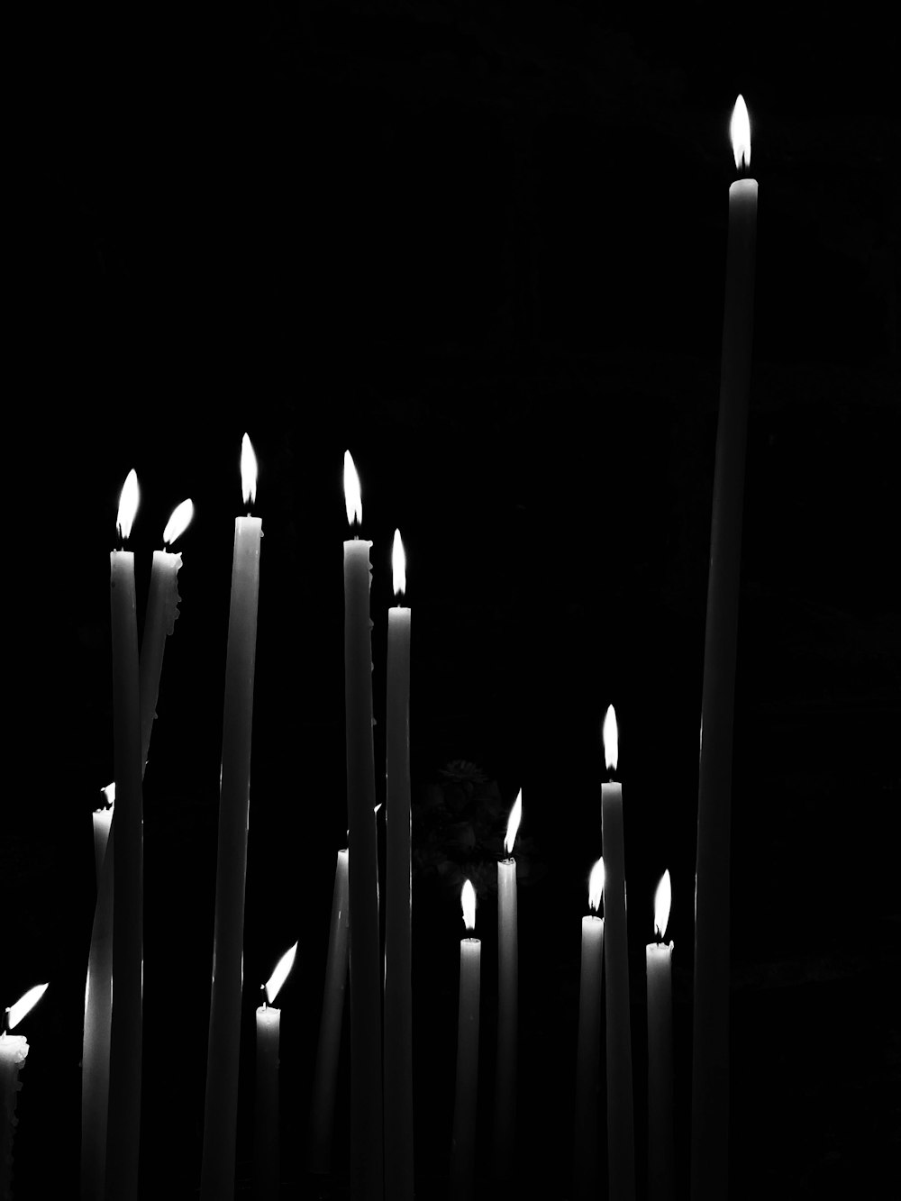 white candles on black background