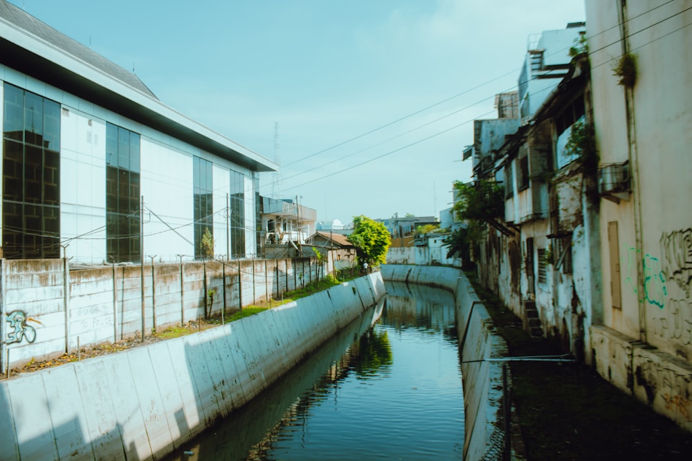 white and gray concrete building beside river during daytime