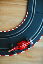 a toy race track with a red race car on it