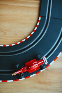 a toy race track with a red race car on it