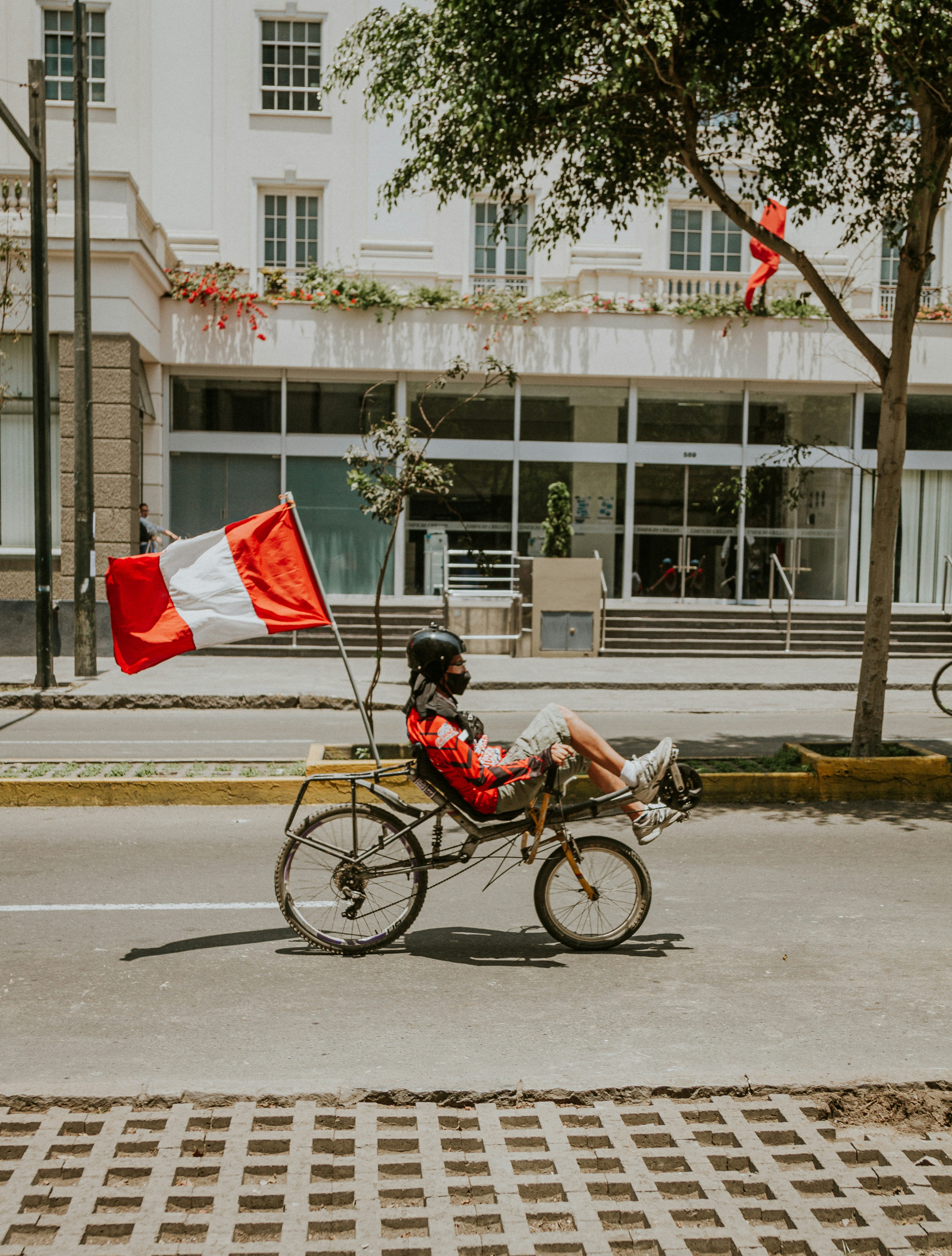 Man in red shirt riding on bicycle on road during daytime photo – Free ...