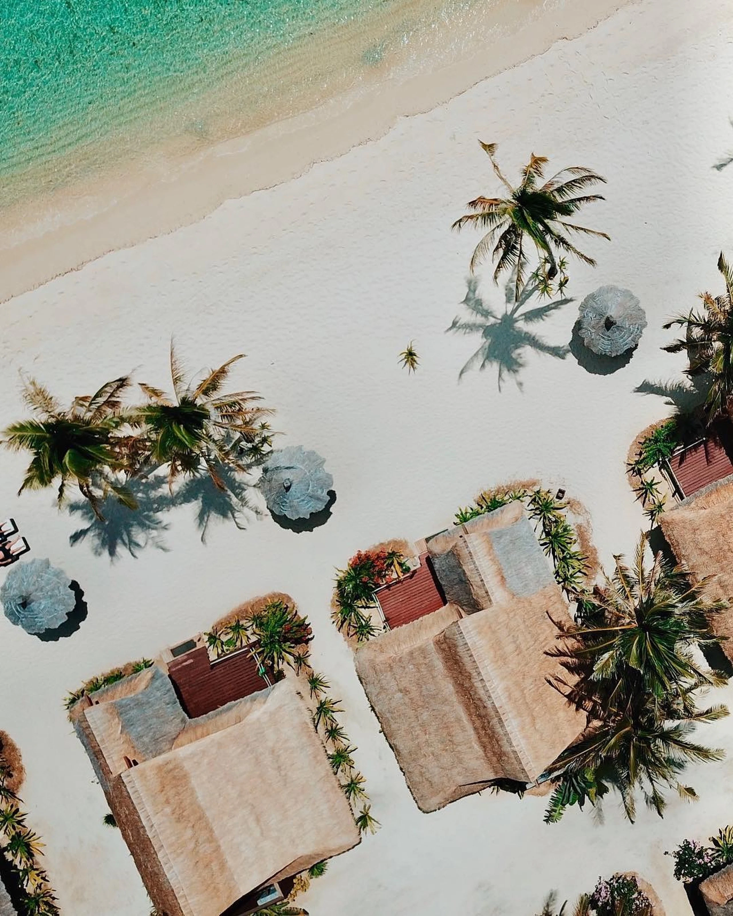 Aerial of beachfront villas among palms, Cauayan Island Resort, El Nido