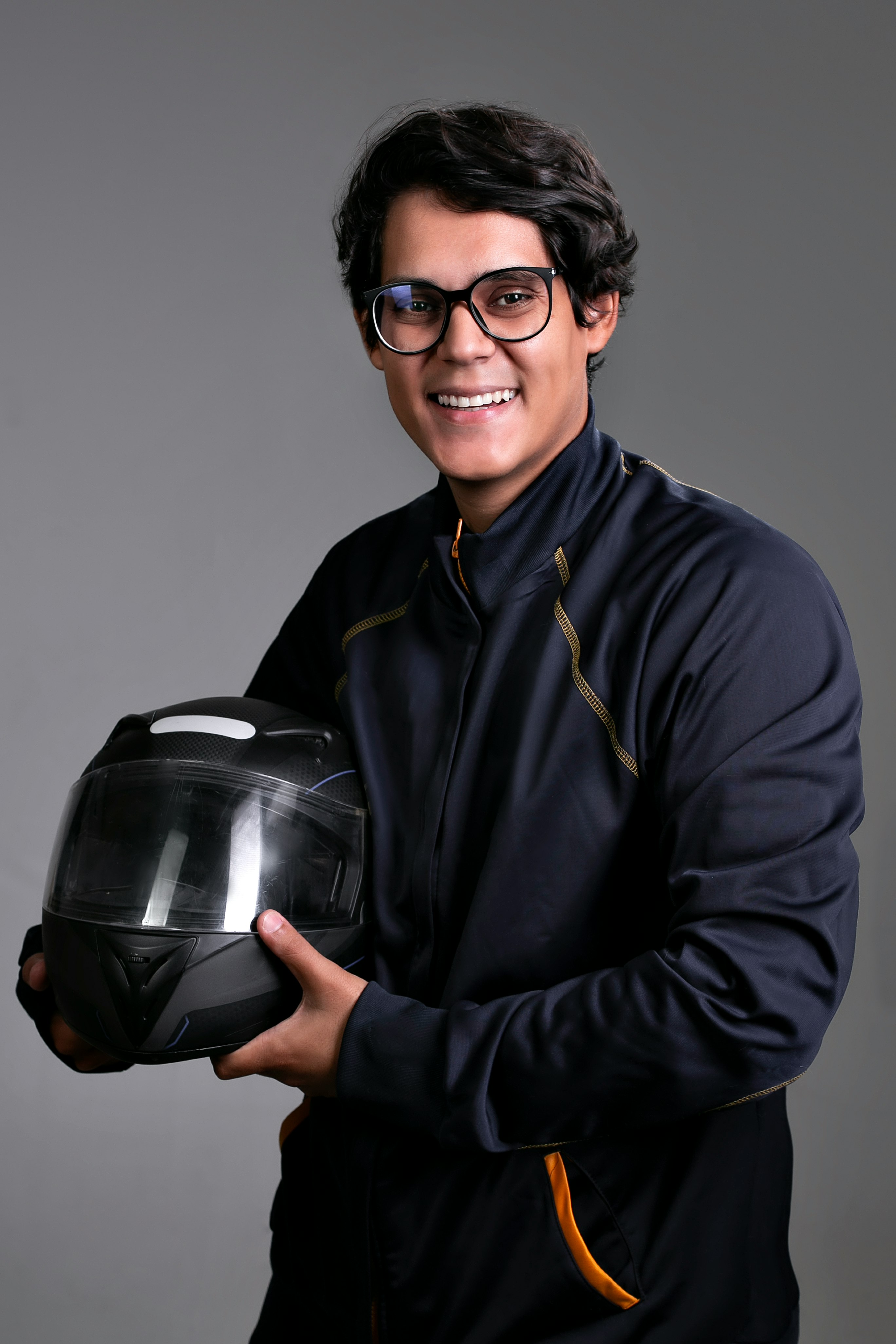 man in black dress shirt holding black helmet