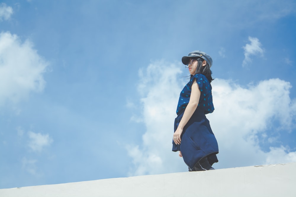 woman in black dress standing under blue sky during daytime