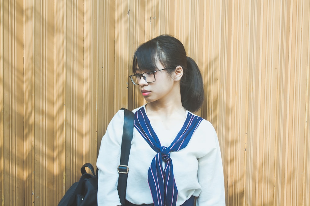 woman in white cardigan wearing black framed eyeglasses