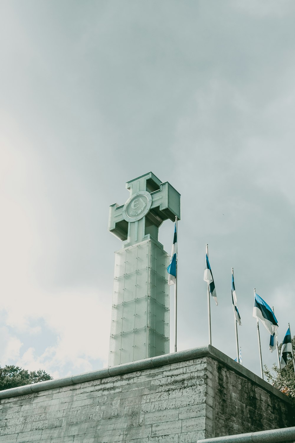 white concrete building with blue flag on top