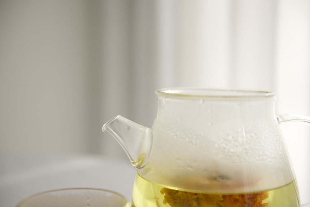 clear glass pitcher with yellow liquid