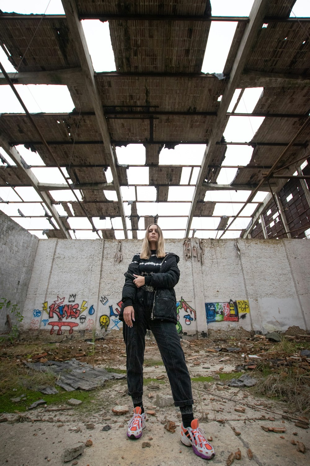 man in black jacket standing near wall