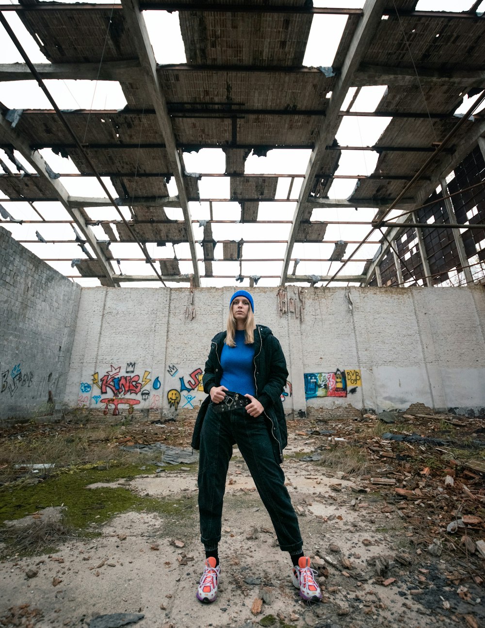 woman in blue denim jacket standing near wall