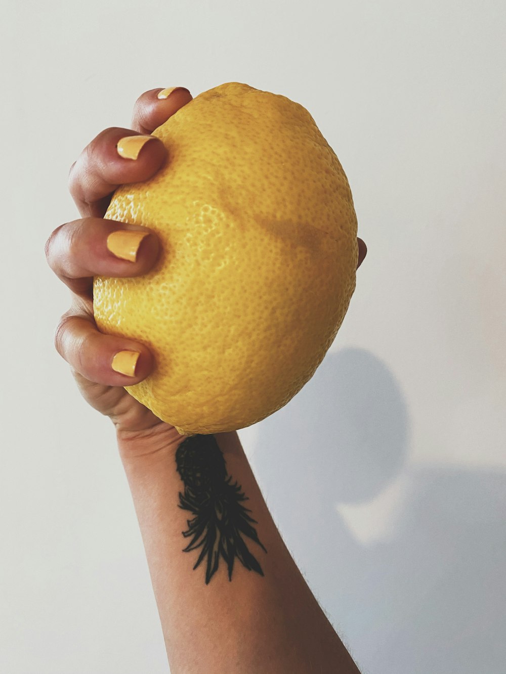 yellow lemon fruit on white surface