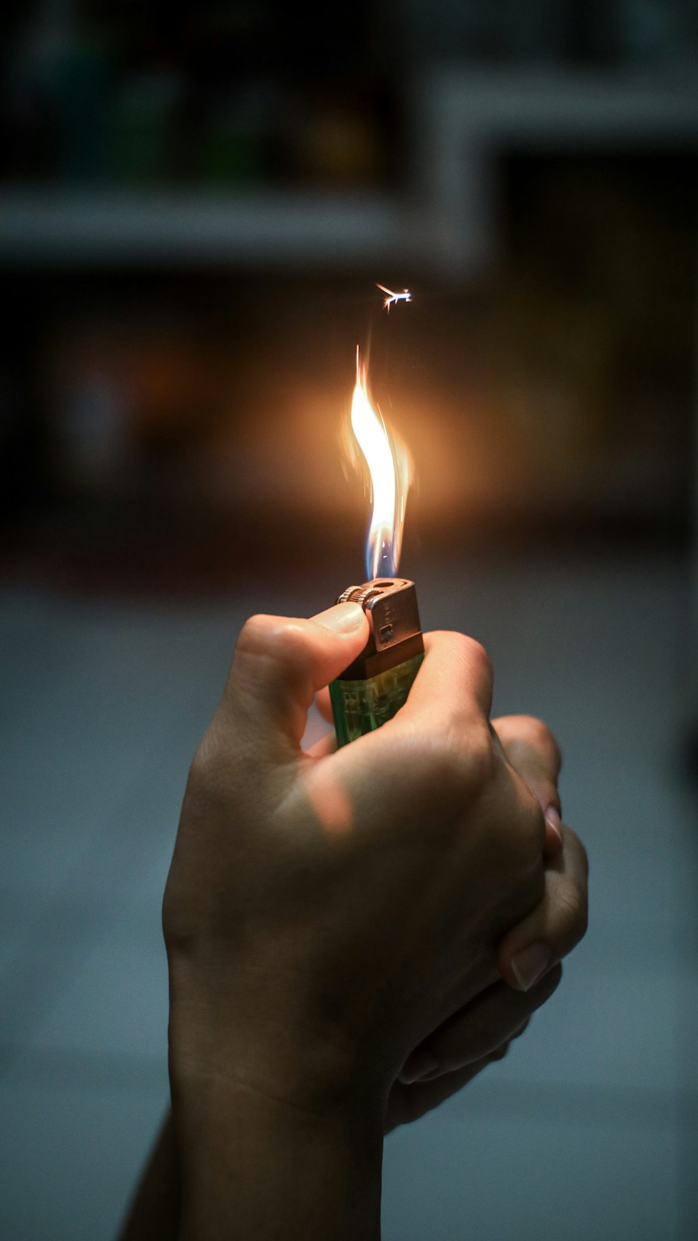 person holding lighter with fire