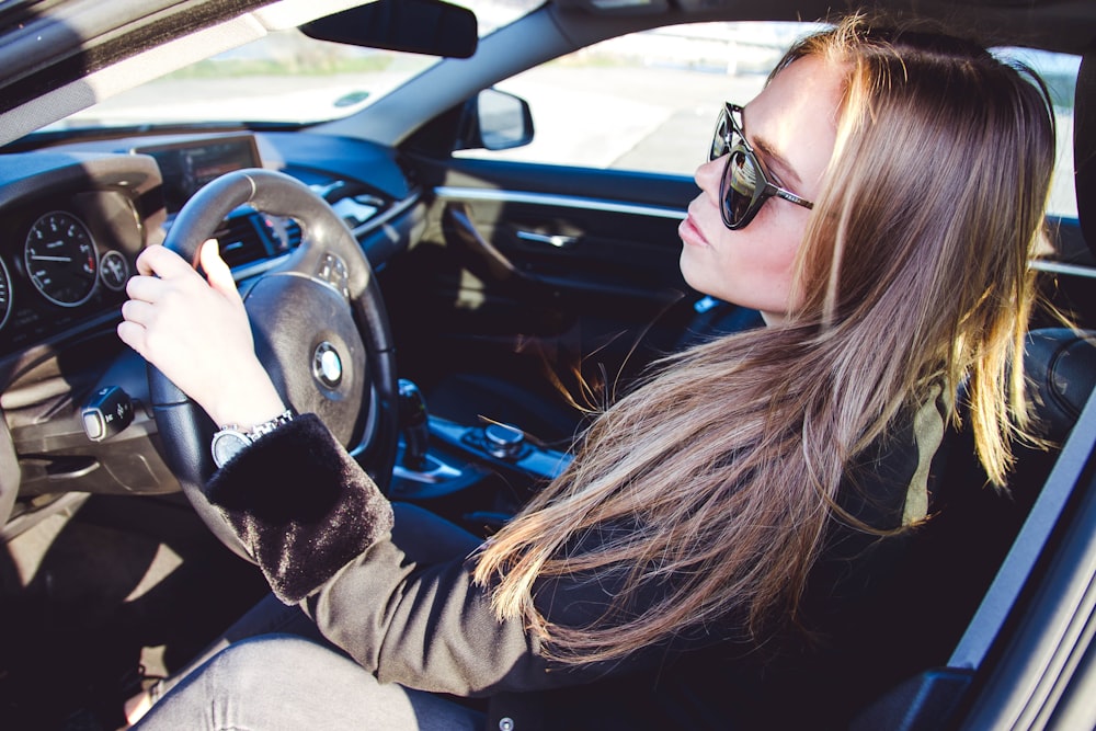 woman in black jacket driving car