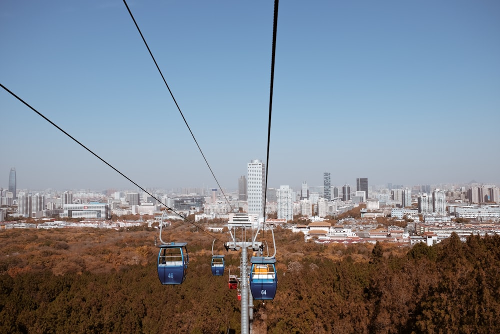 cable cars over city buildings during daytime