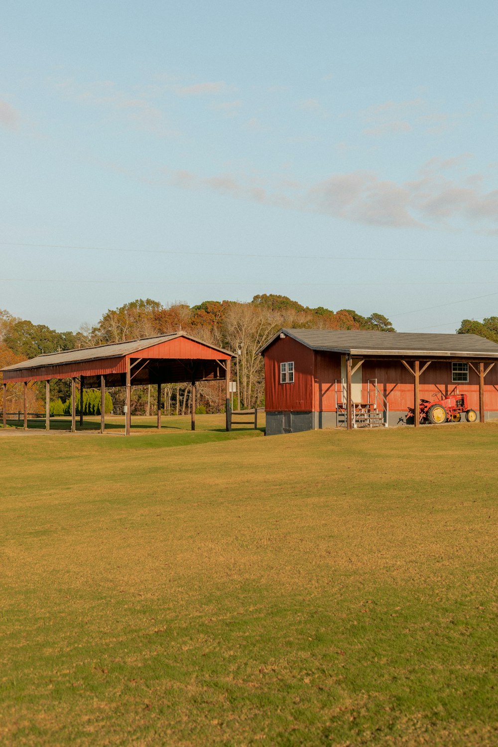 red wooden house on green grass field during daytime