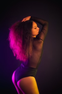 woman in black tank top with pink hair