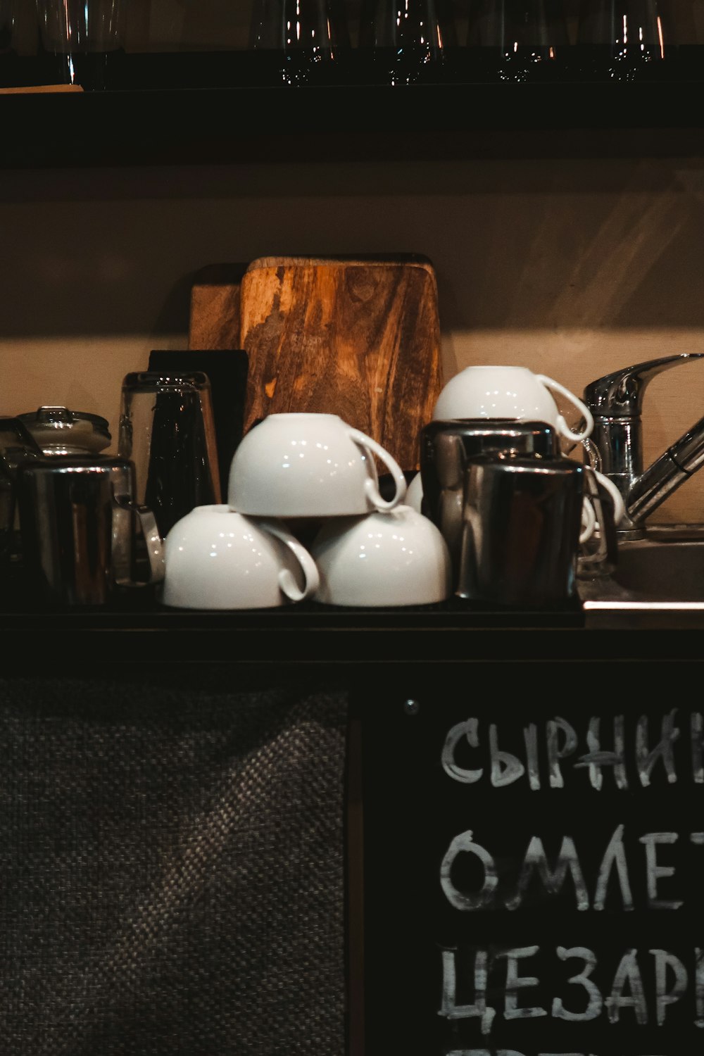 white and black ceramic mugs on black wooden table