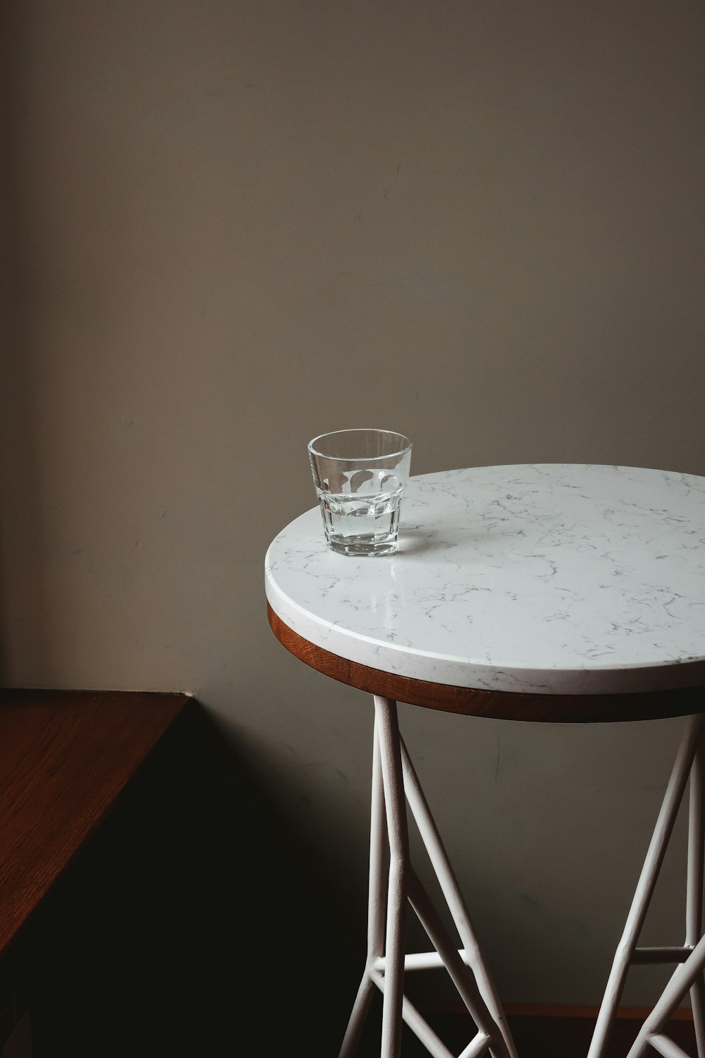 clear drinking glass on white round table