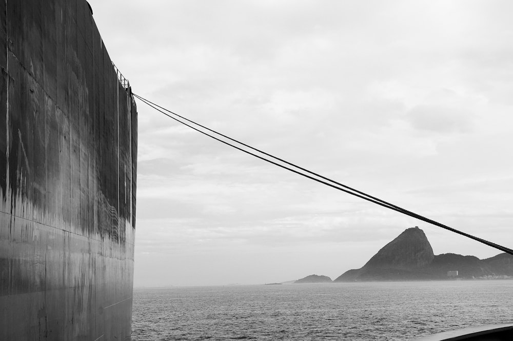 grayscale photo of bridge over the sea