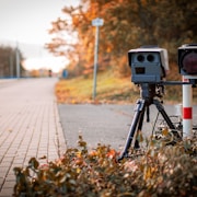 black and gray camera on tripod on road during daytime