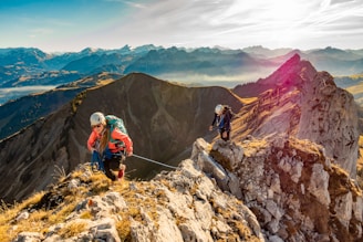 2 men hiking on mountain during daytime