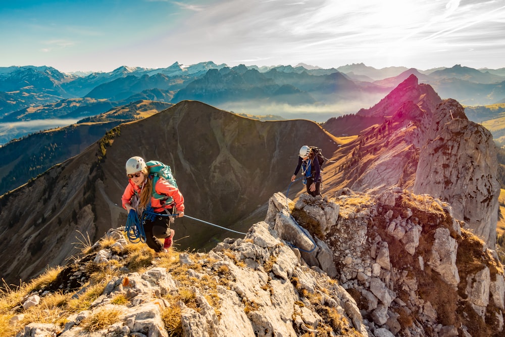 2 men hiking on mountain during daytime