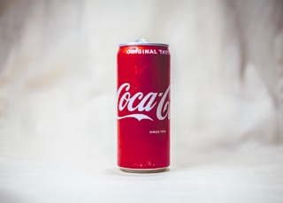 coca cola can on white table