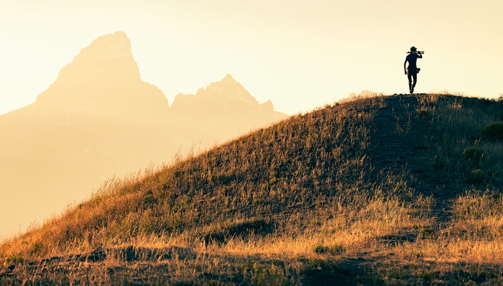 brown grass field near brown mountain during daytime