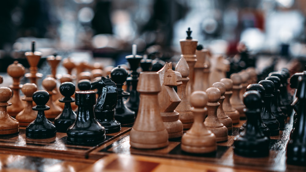 brown wooden chess pieces on chess board