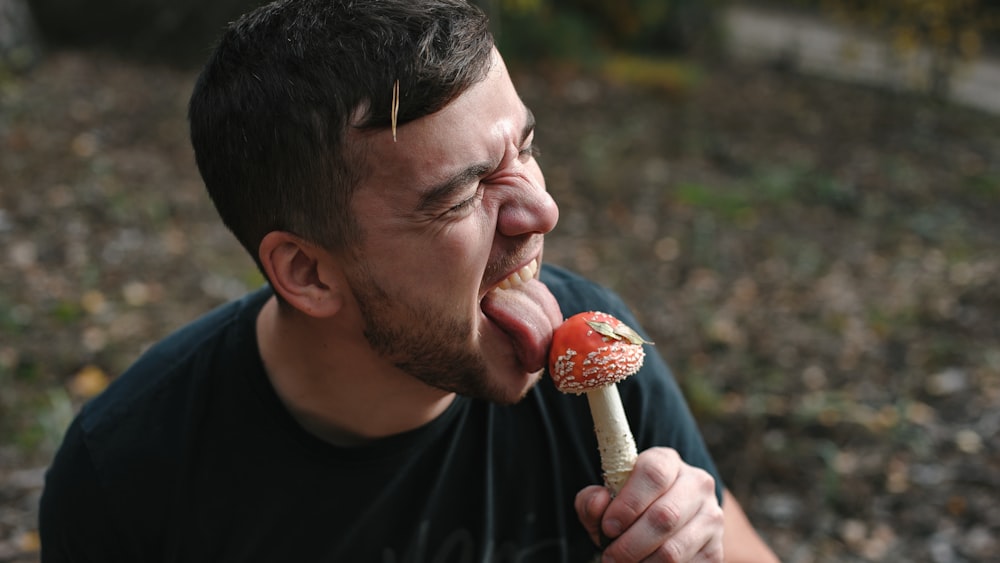 man in black crew neck shirt eating ice cream