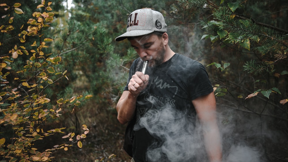 man in black crew neck t-shirt smoking