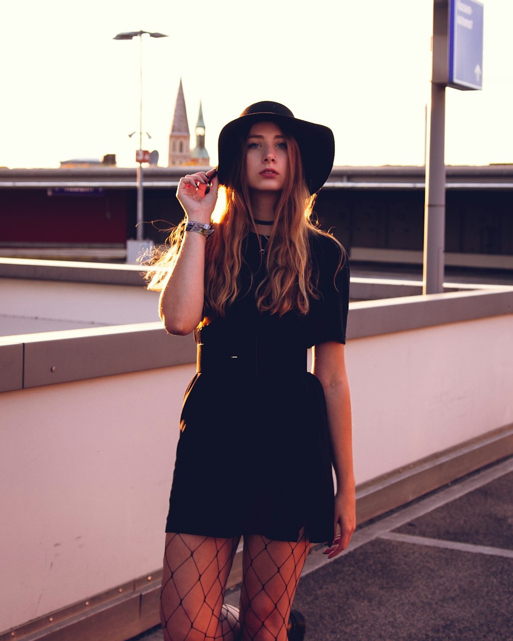 woman in black dress wearing black hat