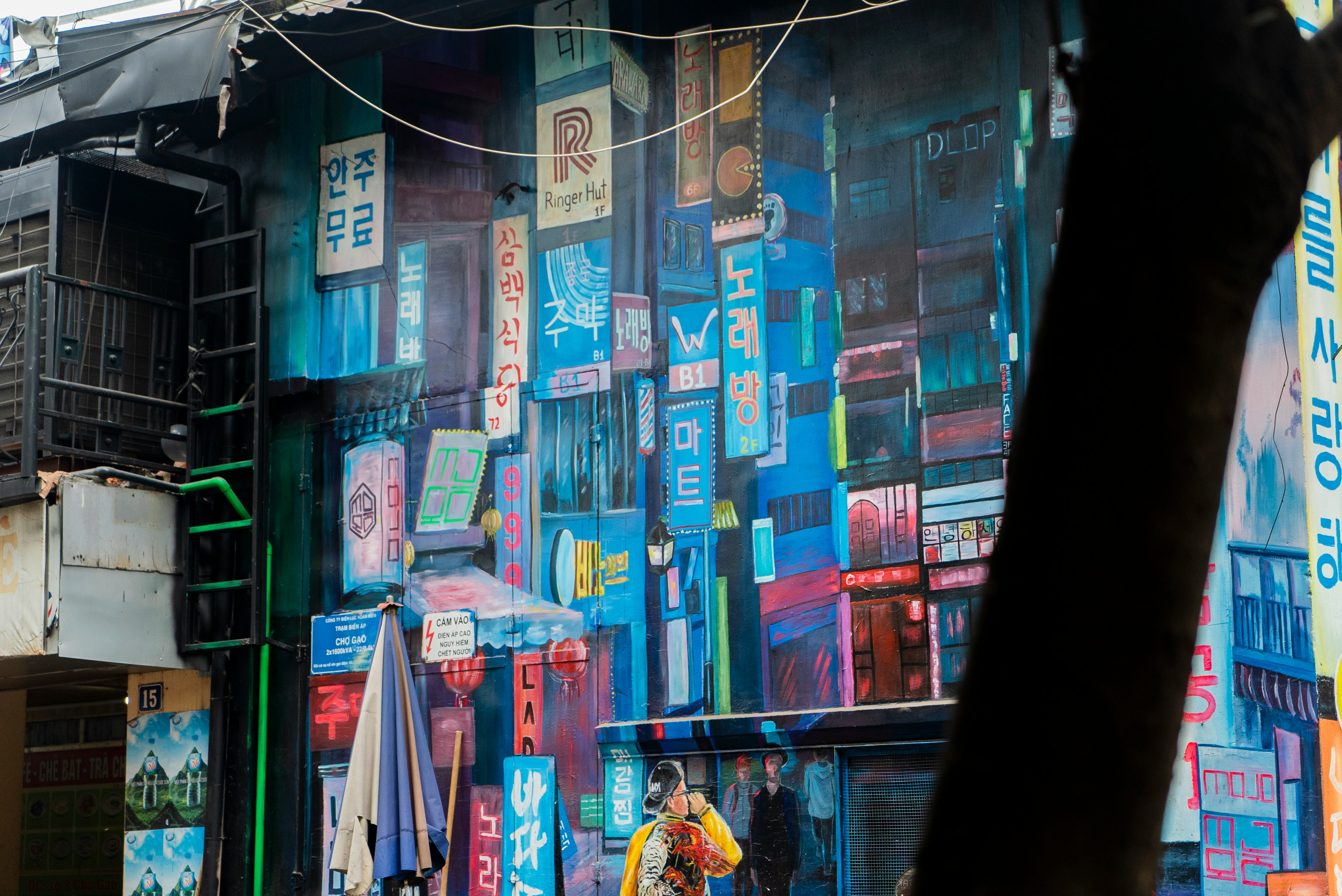 man in yellow shirt standing in front of store