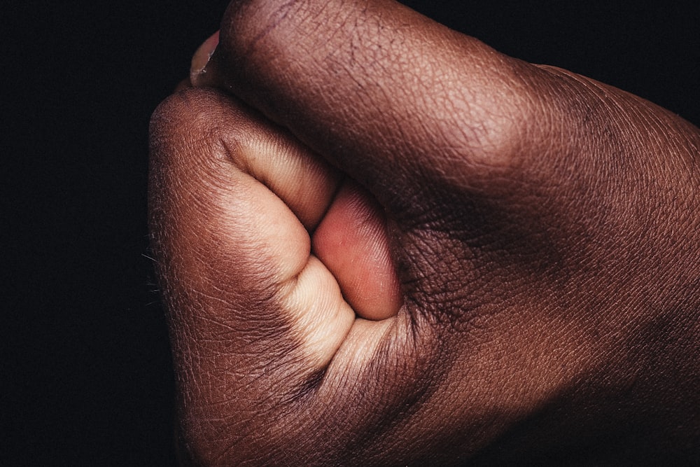 persons hand on black textile