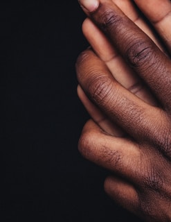 persons hand on black background