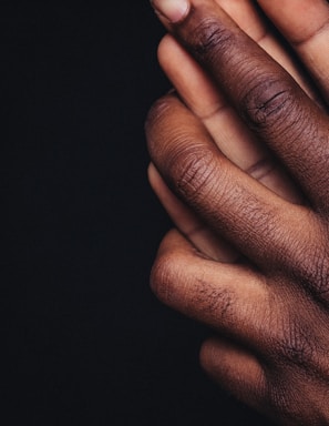 persons hand on black background