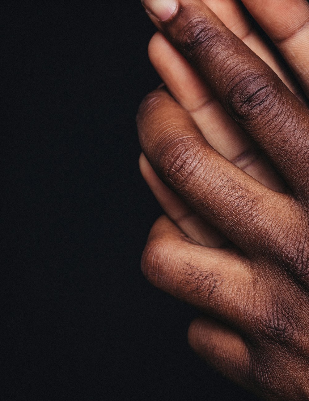 persons hand on black background