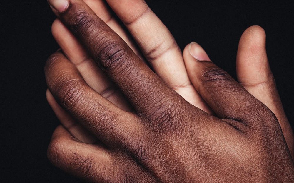 persons left hand on black textile