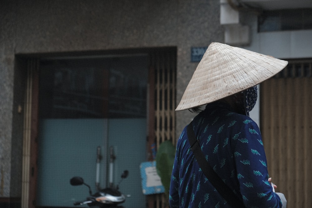 person in blue and black plaid shirt wearing white hat