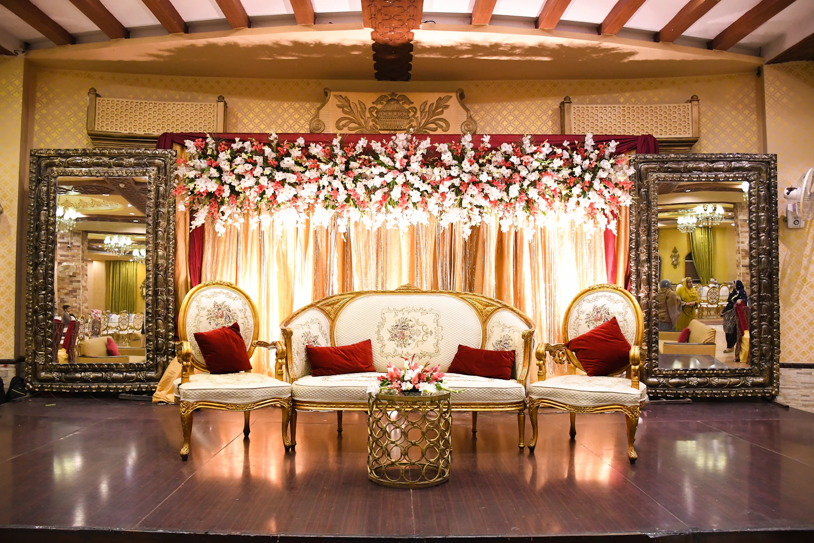 Red and white floral wedding stage setup