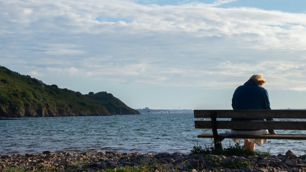 brown wooden bench on seashore during daytime