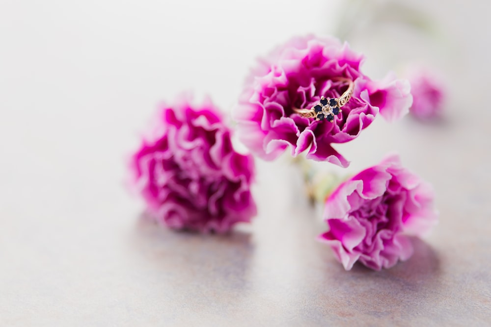 pink flowers on brown wooden table