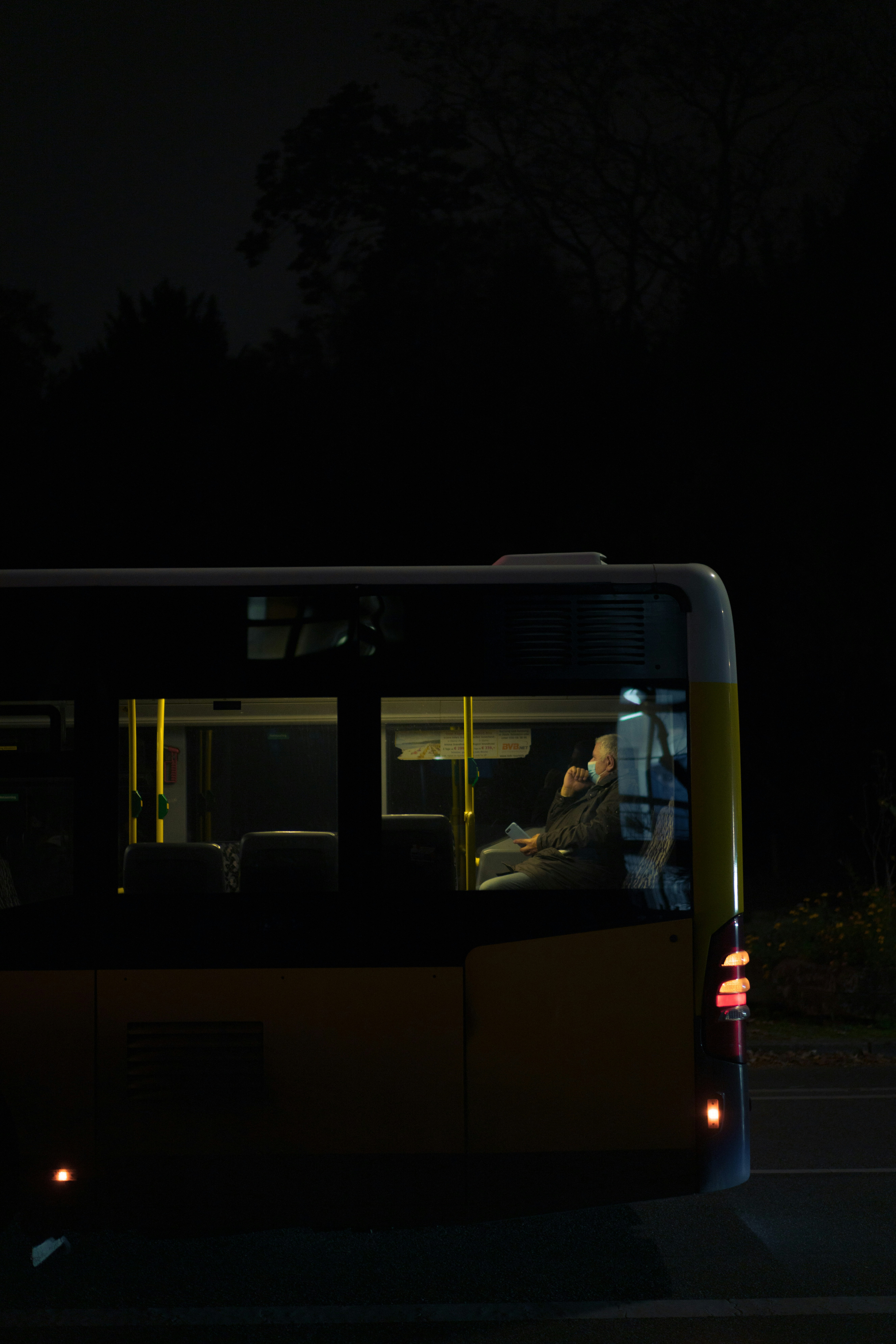 white-and-blue-bus-on-road-during-night-time