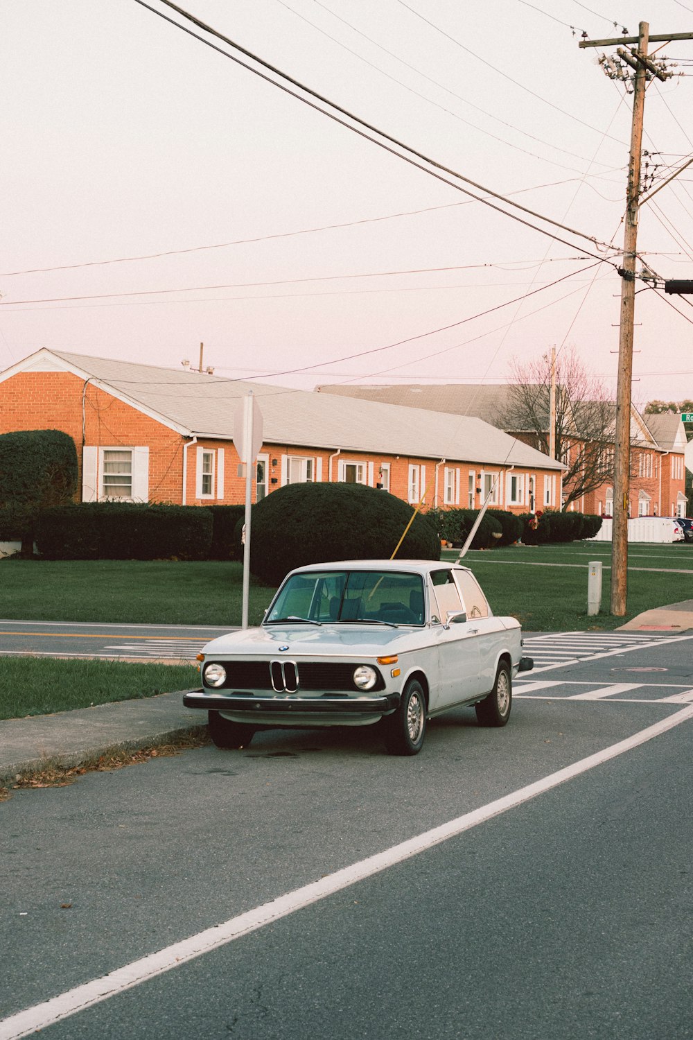 white sedan on road during daytime