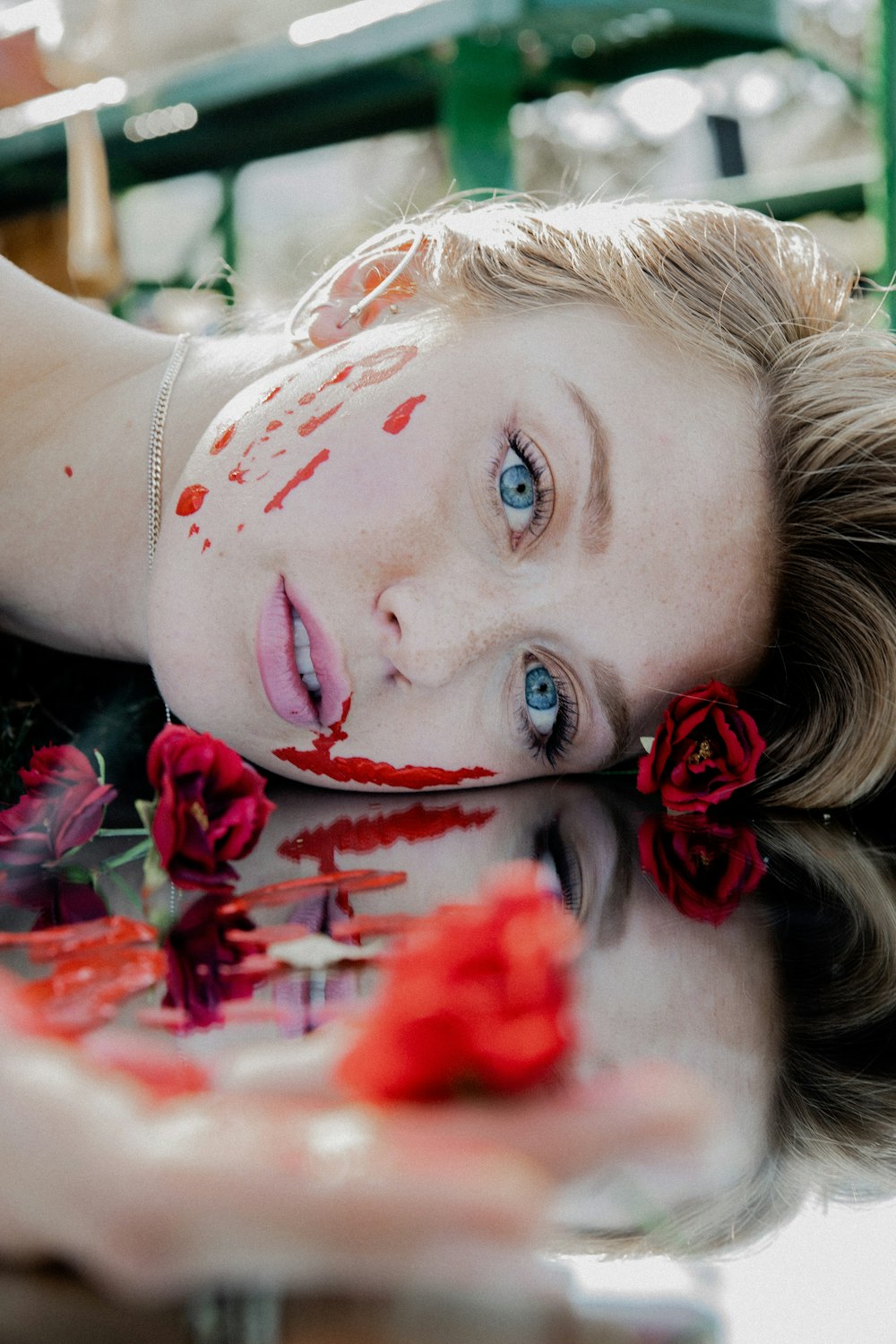 woman with red petals on her head