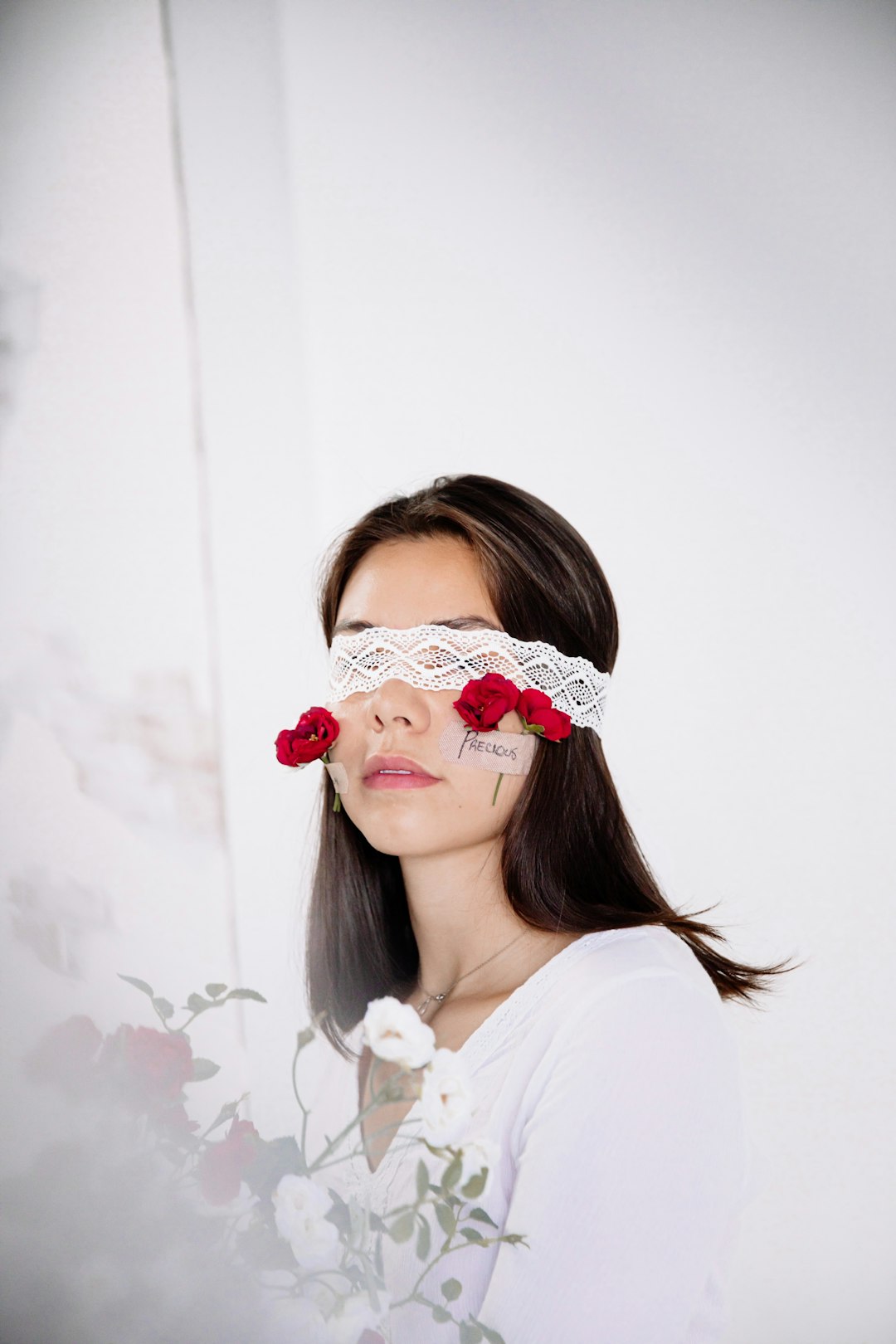 woman in white shirt with red and white floral headband
