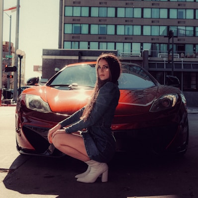 woman in black jacket sitting on black car