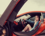 woman in red shirt driving car