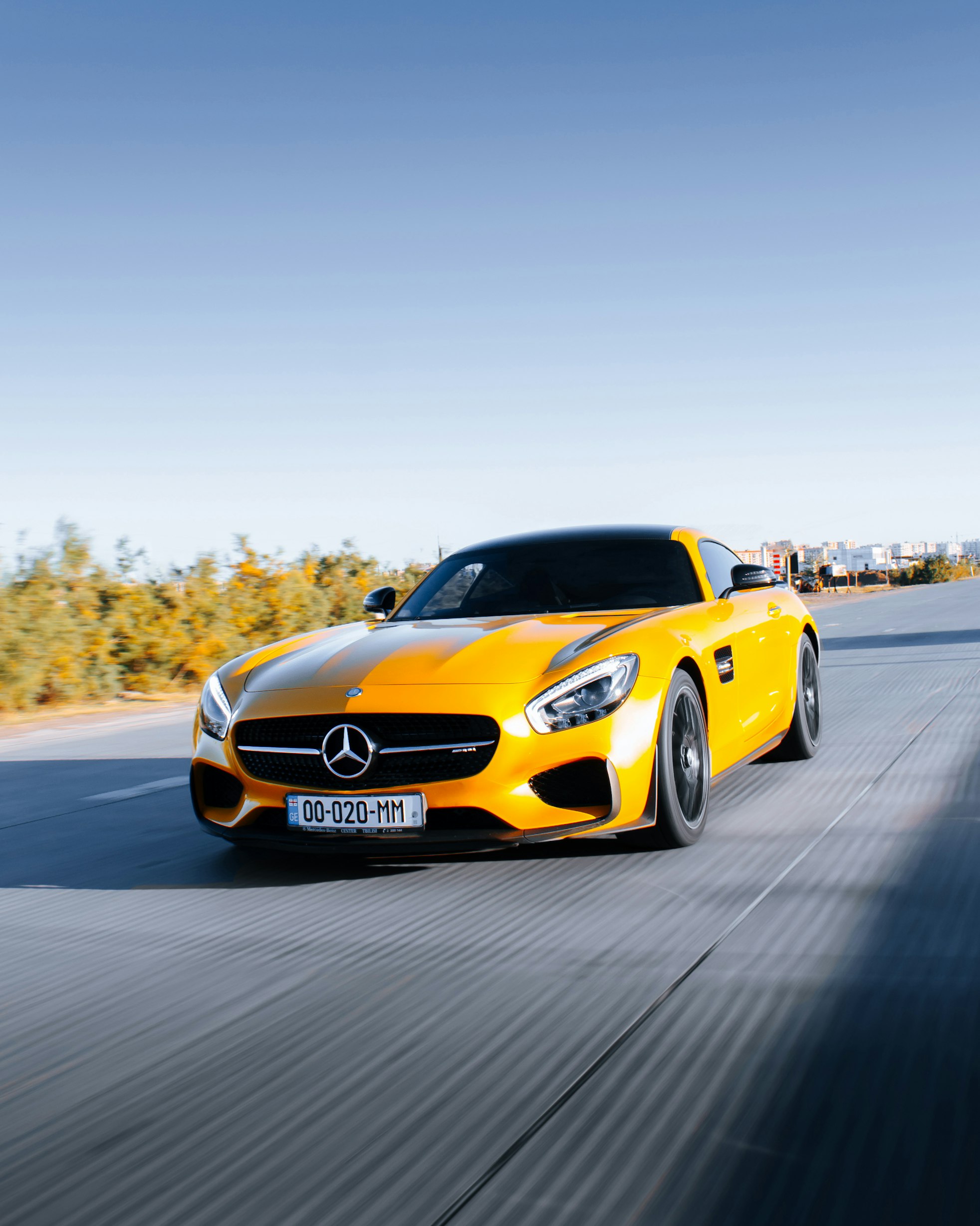 A bright yellow sports car showcasing a vibrant color change wrap.