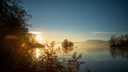 A peaceful sunrise over a quiet lake symbolizing new beginnings and hope.