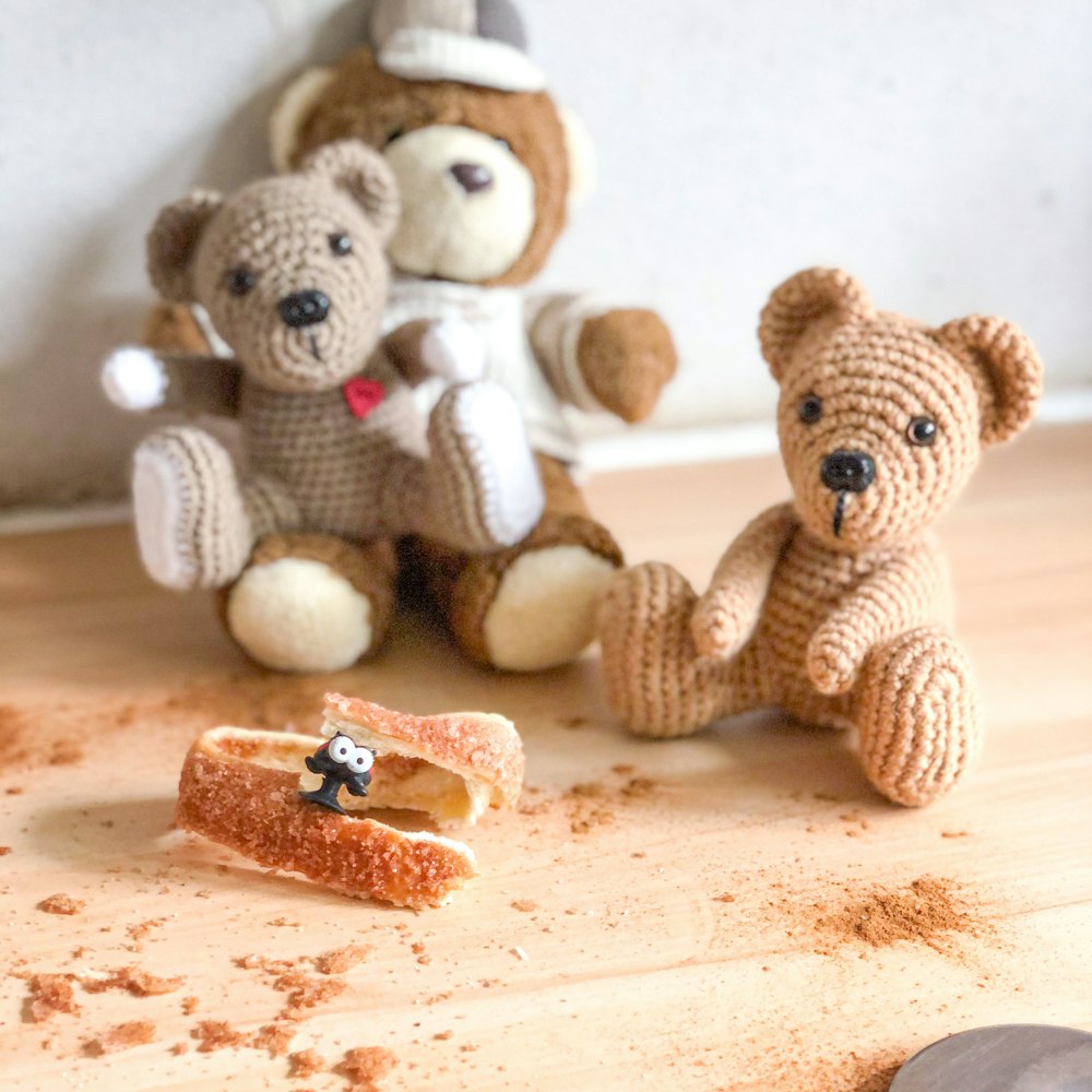 brown bear plush toy on brown wooden table